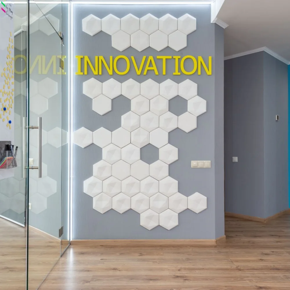 Patterned graphics applied to a glass office partition beside a corridor