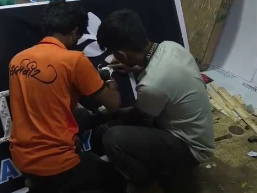 The ART CENTRRAL team assembling a sign board in the workshop